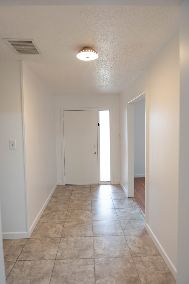 foyer with a textured ceiling