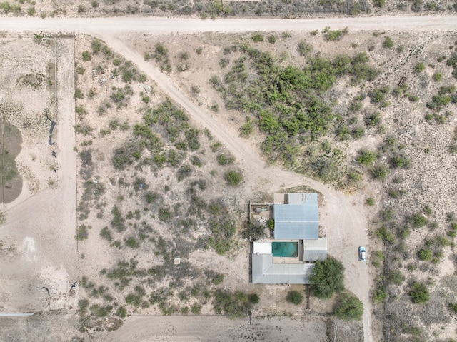 bird's eye view with view of desert and a rural view
