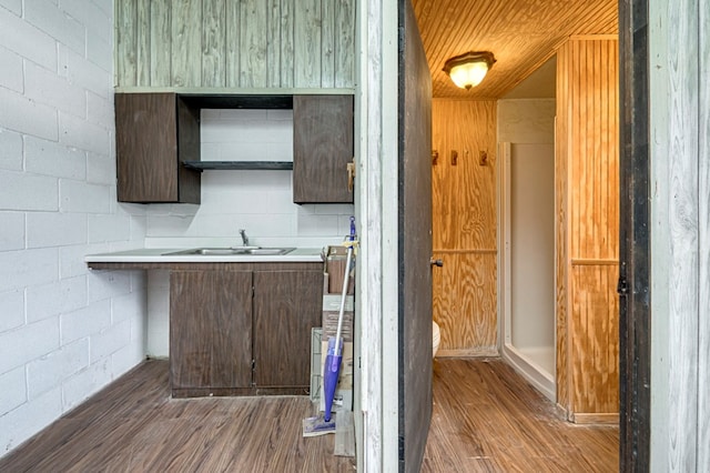details with wood finished floors and a sink