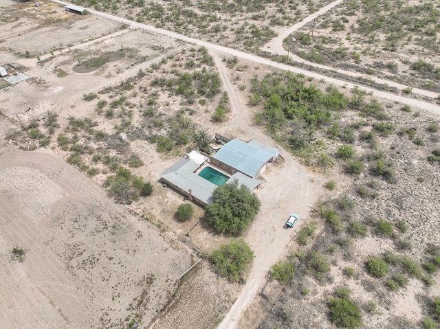 birds eye view of property featuring a rural view and a desert view