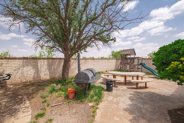 view of jungle gym featuring fence