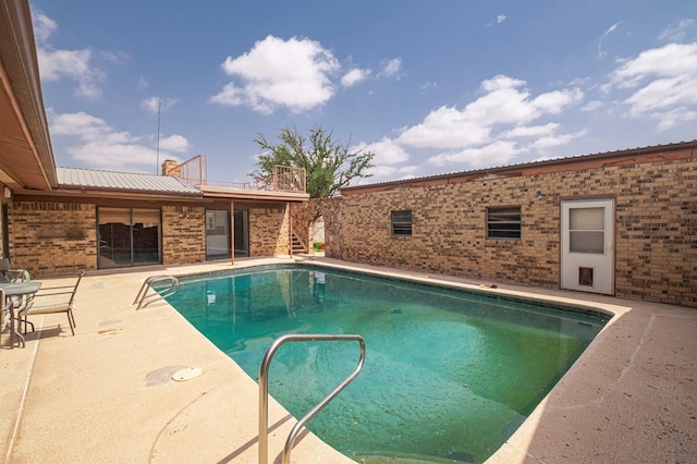 view of pool with a fenced in pool, stairway, and a patio area