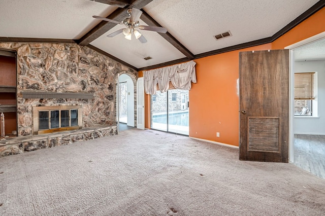 unfurnished living room featuring lofted ceiling with beams, a textured ceiling, ceiling fan, and visible vents