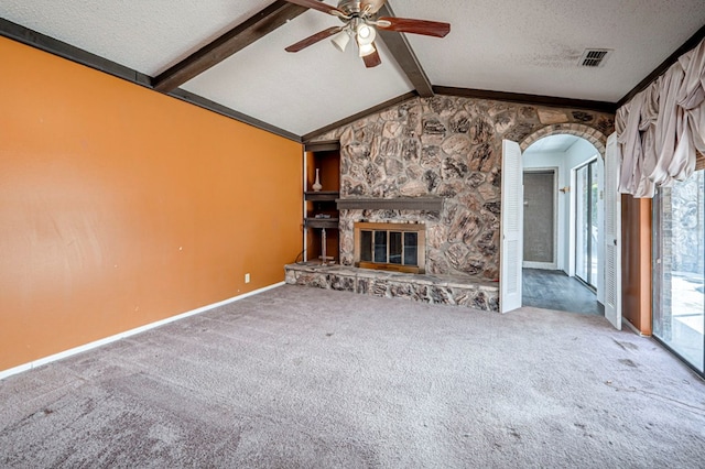 unfurnished living room with vaulted ceiling with beams, carpet floors, ceiling fan, visible vents, and a textured ceiling
