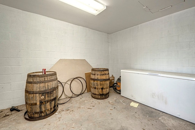 interior space with concrete floors and concrete block wall