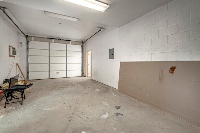 garage featuring a wall unit AC, concrete block wall, and electric panel