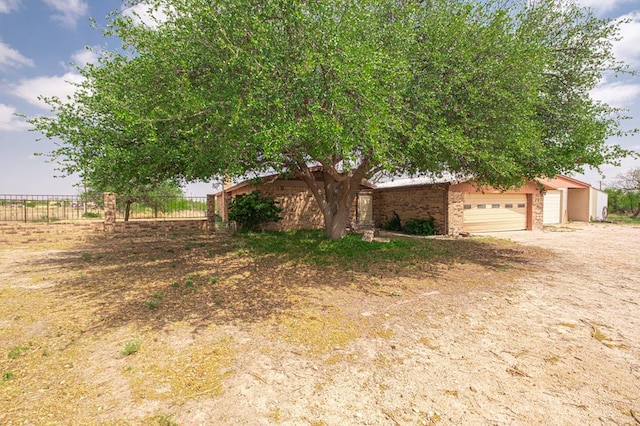 view of front of house featuring a garage and fence