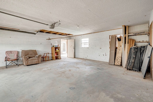 garage with concrete block wall and a garage door opener