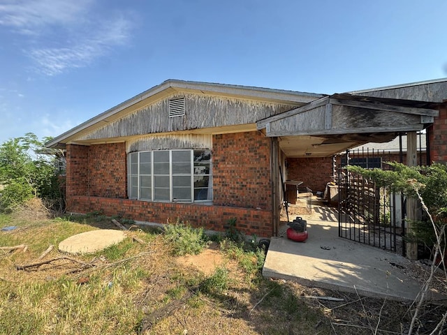 1516 E Old Colorado City Hwy, Big Spring, TX 79720 - view of property exterior with a patio and brick siding