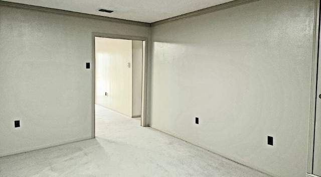 unfurnished room featuring ornamental molding, visible vents, and light carpet