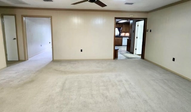 unfurnished room featuring light carpet, ceiling fan, visible vents, and crown molding