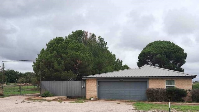 garage with driveway and fence