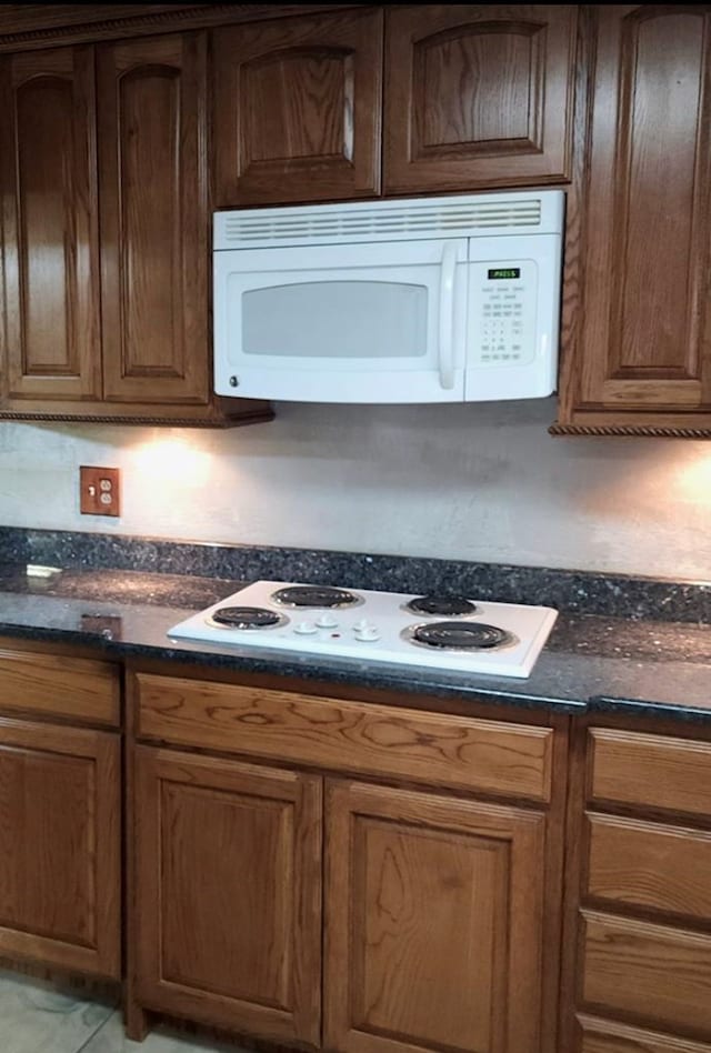 kitchen with white appliances and brown cabinets