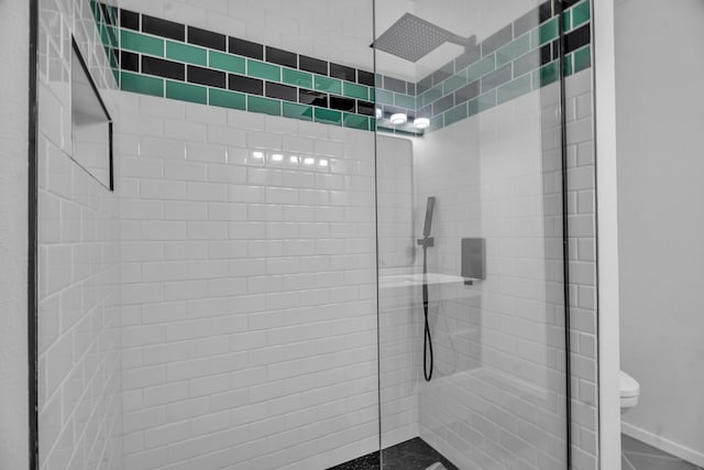 bathroom featuring toilet and walk in shower