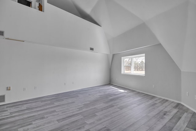 bonus room featuring visible vents, vaulted ceiling, and wood finished floors