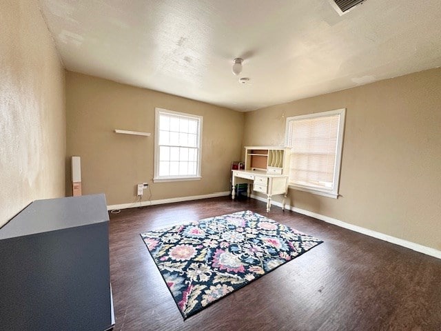 office space featuring visible vents, baseboards, and dark wood-style flooring