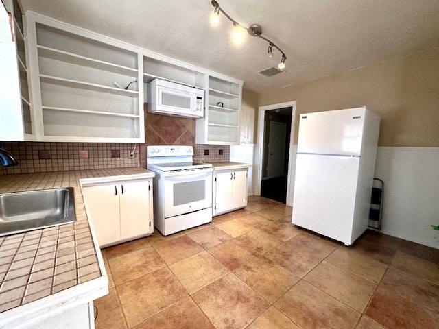 kitchen with open shelves, visible vents, white cabinets, a sink, and white appliances