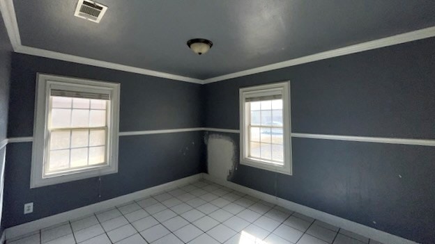 tiled spare room with crown molding