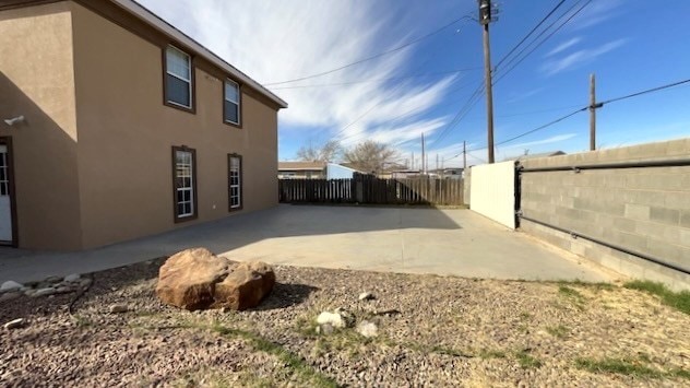 view of side of home with a patio area