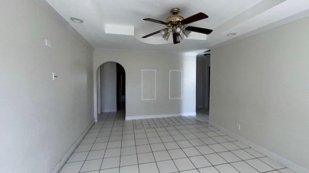 empty room with ceiling fan and ornamental molding