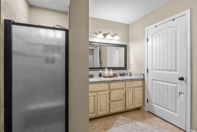 bathroom featuring vanity and a shower with shower door