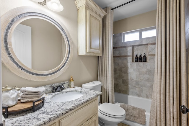 full bathroom with vanity, shower / tub combo with curtain, and toilet