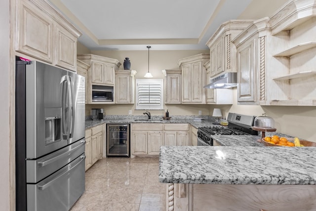 kitchen with appliances with stainless steel finishes, beverage cooler, a raised ceiling, decorative light fixtures, and kitchen peninsula