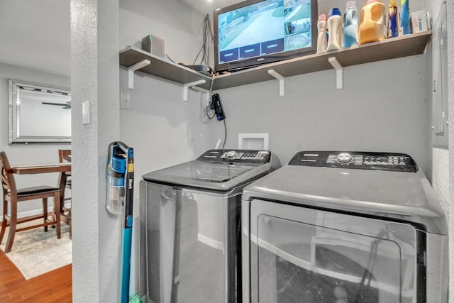 1722 Purdue Ave, Big Spring, TX 79720 - laundry room with wood finished floors and washer and clothes dryer