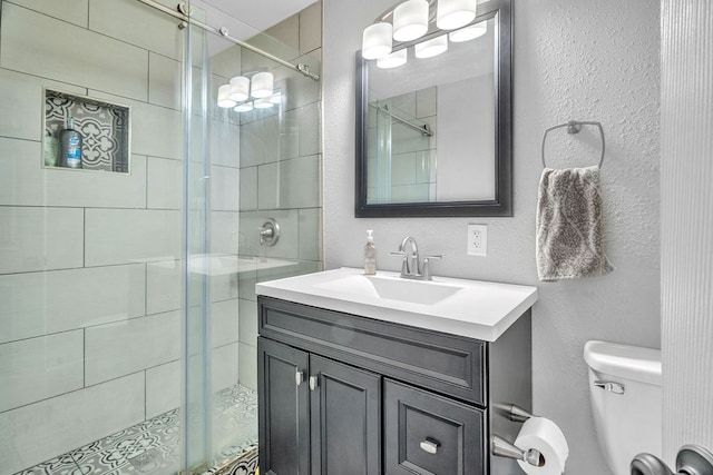 1722 Purdue Ave, Big Spring, TX 79720 - bathroom featuring toilet, a stall shower, vanity, and a textured wall