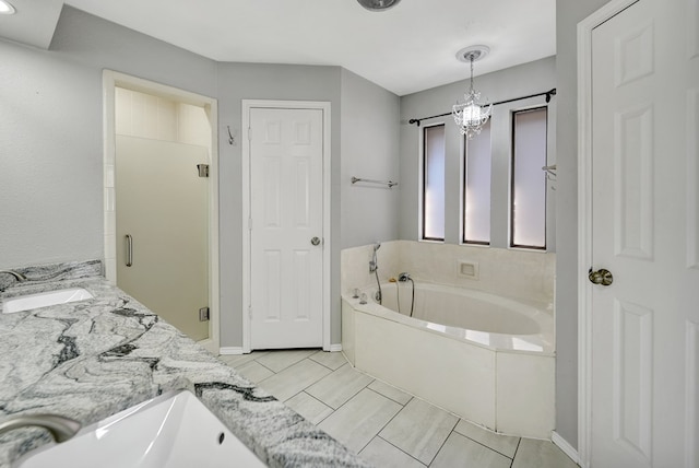 full bath with a stall shower, a sink, double vanity, baseboards, and a bath