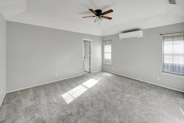 empty room featuring baseboards, carpet floors, ceiling fan, vaulted ceiling, and a wall mounted air conditioner