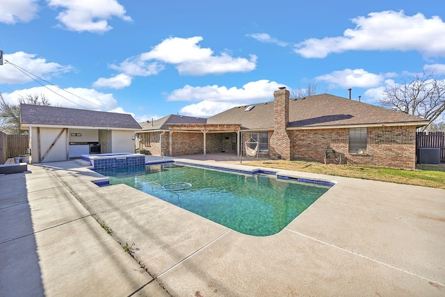 view of pool with a patio, fence, a pergola, and a pool with connected hot tub