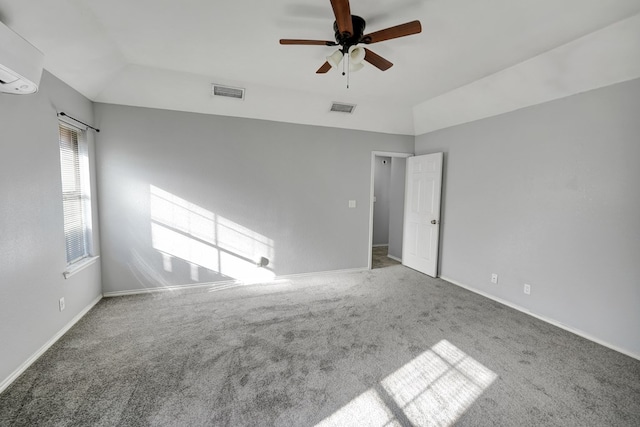 empty room with visible vents, carpet floors, and vaulted ceiling