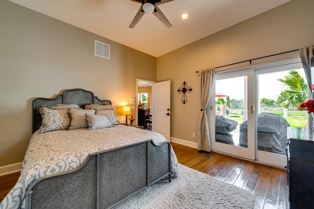 bedroom with hardwood / wood-style flooring, ceiling fan, access to exterior, and vaulted ceiling