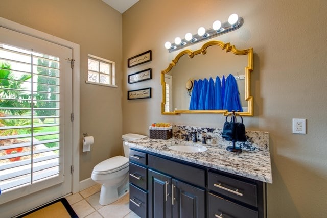 bathroom with tile patterned floors, vanity, and toilet