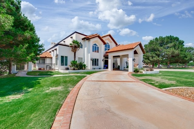 mediterranean / spanish home featuring a front lawn