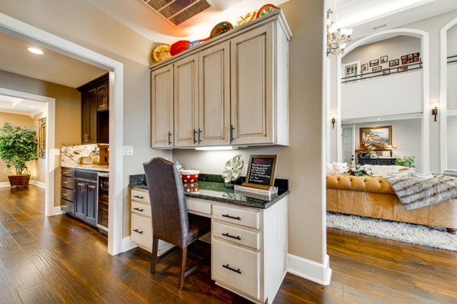 office space featuring dark hardwood / wood-style floors, built in desk, and a chandelier