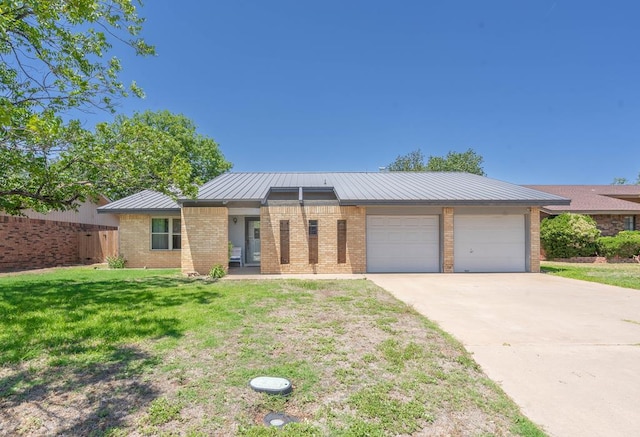 1509 Cascade Ct, Midland, TX 79703 - view of front of home with an attached garage, brick siding, concrete driveway, a metal roof, and a standing seam roof