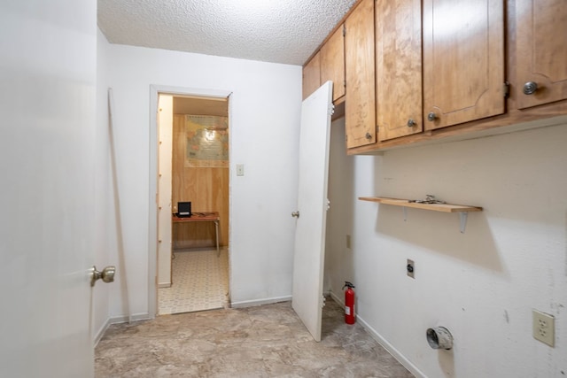 1509 Cascade Ct, Midland, TX 79703 - laundry room with cabinet space, a textured ceiling, hookup for an electric dryer, and light floors