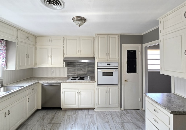 kitchen with decorative backsplash, sink, white appliances, and ornamental molding