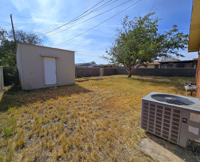 view of yard with cooling unit and a shed