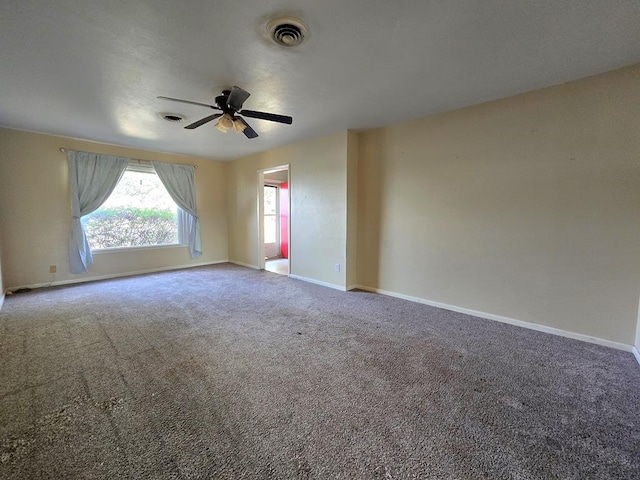 carpeted empty room featuring ceiling fan