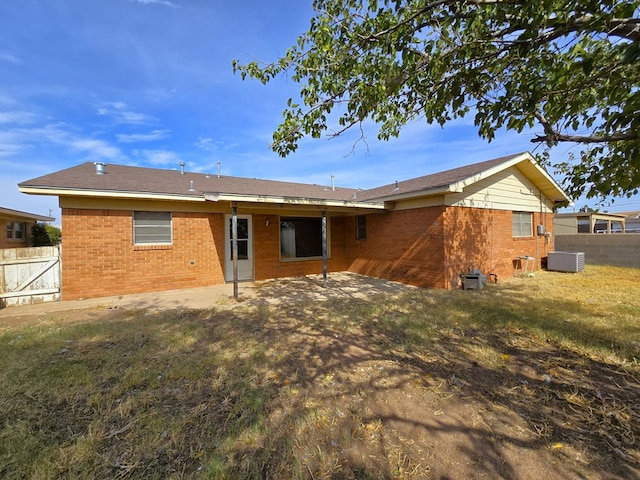 back of house with a yard, a patio, and central AC