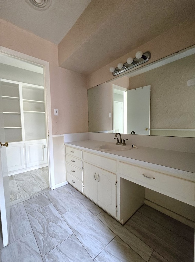 bathroom featuring vanity and a textured ceiling