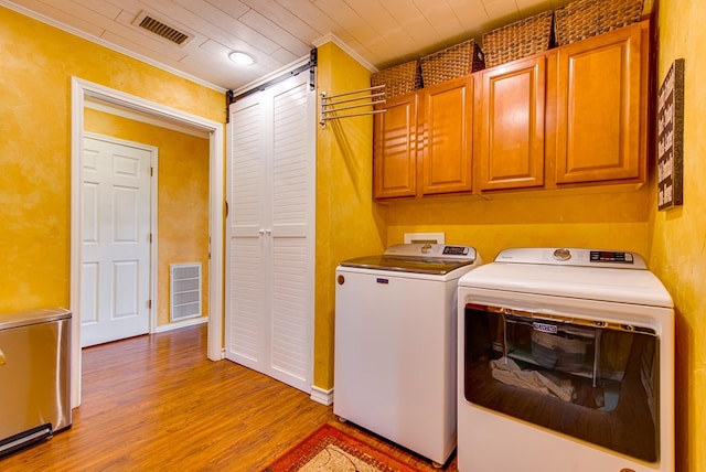 10903 E County Rd 105, Midland, TX 79706 - laundry area with washing machine and dryer, cabinet space, light wood finished floors, and crown molding