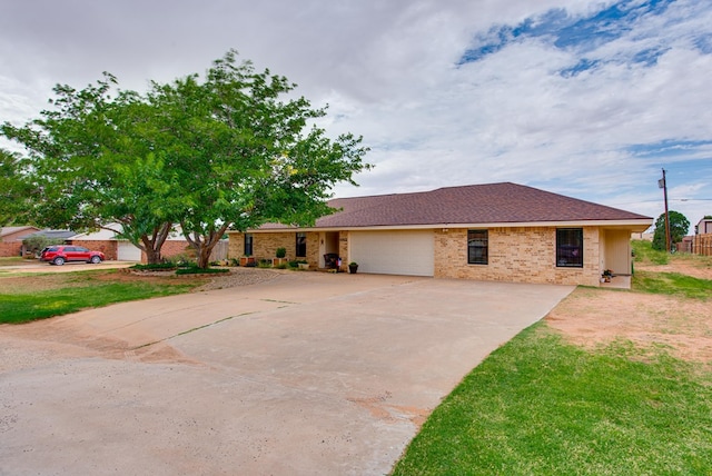10903 E County Rd 105, Midland, TX 79706 - ranch-style home with an attached garage, driveway, and brick siding