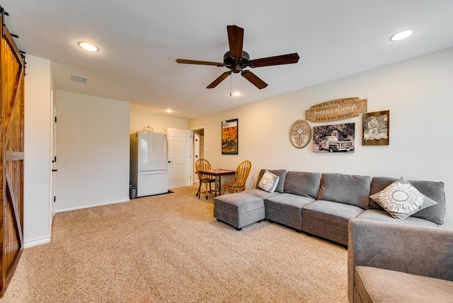 10903 E County Rd 105, Midland, TX 79706 - living room with a barn door, light colored carpet, ceiling fan, recessed lighting, and baseboards