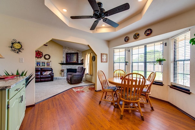 10903 E County Rd 105, Midland, TX 79706 - dining space featuring plenty of natural light, light wood-style floors, a stone fireplace, a ceiling fan, and recessed lighting