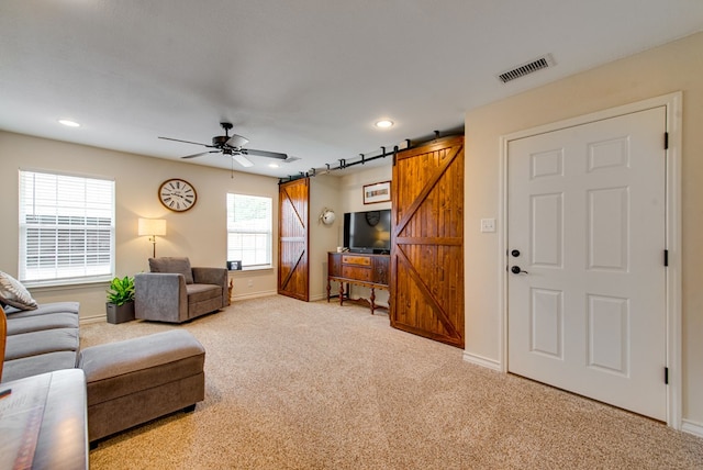 10903 E County Rd 105, Midland, TX 79706 - carpeted living room featuring a barn door, ceiling fan, recessed lighting, and baseboards