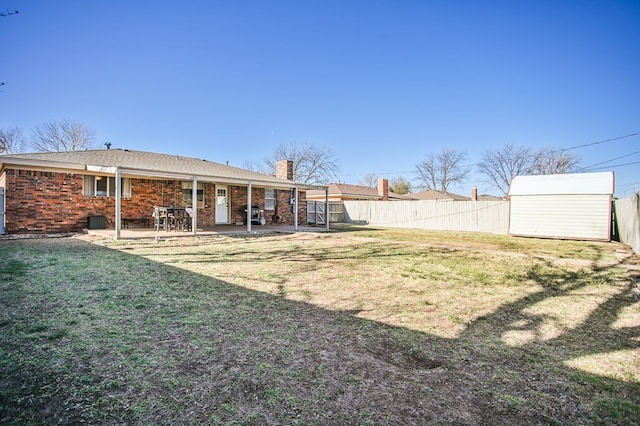 3405 44th St, Snyder, TX 79549 - view of yard with a fenced backyard, an outbuilding, a shed, and a patio area